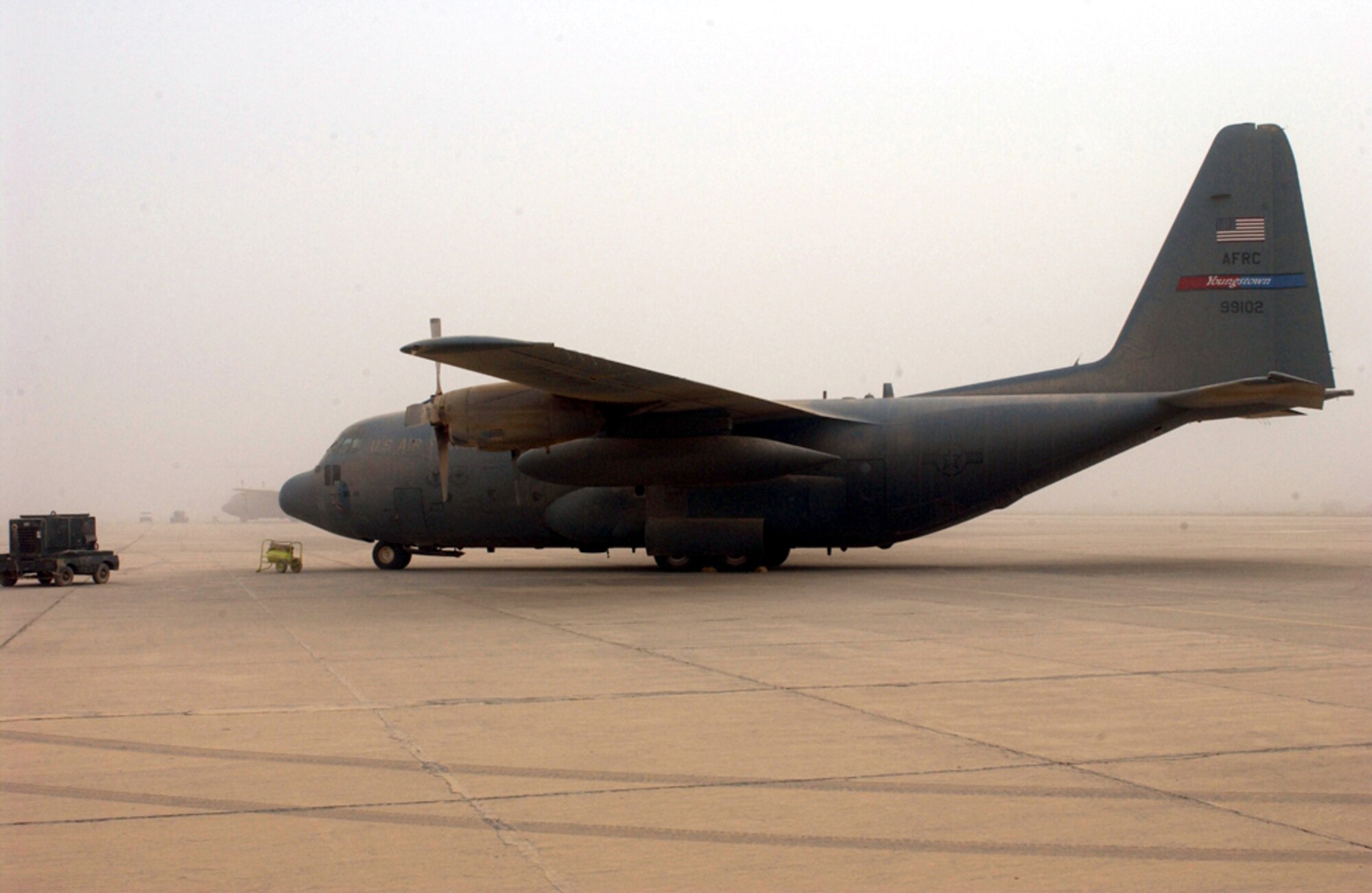 BAGHDAD, Iraq -- A C-130 Hercules sits grounded because of poor visibility from an overnight sandstorm that brought 40 mph winds and a blanket of dust here recently.  The C-130 is assigned to the 910th Airlift Wing in Youngstown, Ohio.  (U.S. Air Force photo by Tech. Sgt. Brian Davidson)                   
