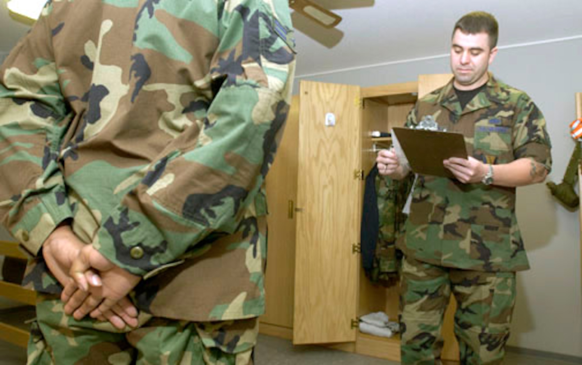 RAMSTEIN AIR BASE, Germany -- Staff Sgt. Joseph Gallina takes notes while inspecting a Ramstein's Area Motivational Program candidate's room.  This 30-day program is used by commanders to "reblue" airmen basics through staff sergeants, whose attitude or behavior has deteriorated, resulting in nonjudicial punishment.  The program has been in place here since January 2004 with a high success rate.  Sergeant Gallina is the noncommissioned officer in charge of the program.  (U.S. Air Force photo by Master Sgt. John E. Lasky)