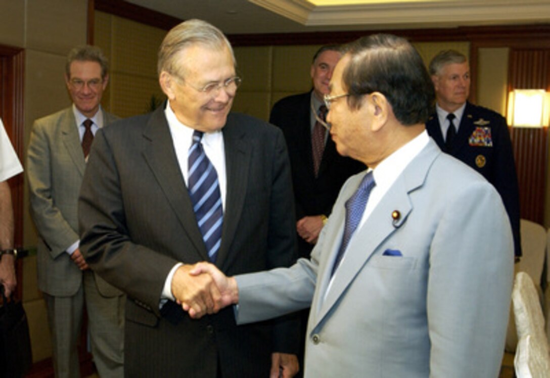 Secretary of Defense Donald H. Rumsfeld (left) shakes hands with Director General of the Japan Defense Agency Yoshinori Ohno prior to a bilateral meeting at the 4th International Institute for Strategic Studies Asia Security Conference: The Shangri- La Dialogue in Singapore on June 4, 2005. The Asia Security Conference brings ministers of defense and other senior officials of Pacific nations together to discuss such topics as terrorism, piracy and defense capabilities in the region. 