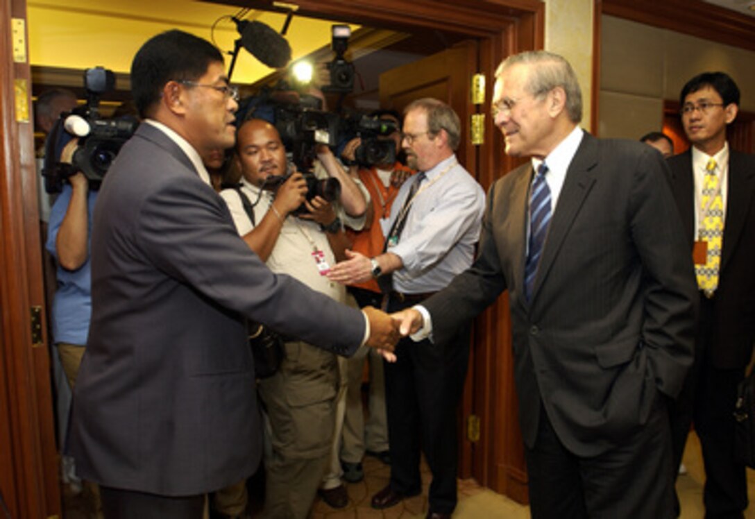 Secretary of Defense Donald H. Rumsfeld (right) shakes hands with Philippines Secretary of National Defense Avelino Cruz prior to a bilateral meeting at the 4th International Institute for Strategic Studies Asia Security Conference: The Shangri-La Dialogue in Singapore on June 4, 2005. The Asia Security Conference brings ministers of defense and other senior officials of Pacific nations together to discuss such topics as terrorism, piracy and defense capabilities in the region. 