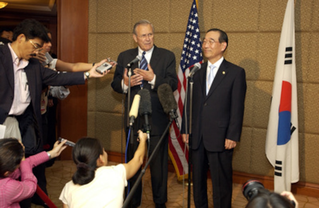 Secretary of Defense Donald H. Rumsfeld (left) and South Korean Minister of National Defense Yoon Kwang Ung conduct a short press briefing after their meeting at the 4th International Institute for Strategic Studies Asia Security Conference: The Shangri-La Dialogue in Singapore on June 4, 2005. The Asia Security Conference brings ministers of defense and other senior officials of Pacific nations together to discuss such topics as terrorism, piracy and defense capabilities in the region. 