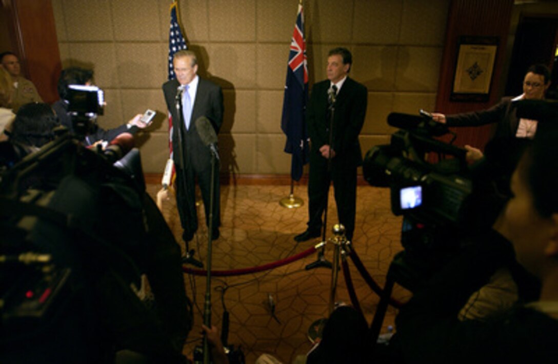 Secretary of Defense Donald H. Rumsfeld (left) and Australia Minister for Defense Senator Robert Hill conduct a press briefing after their meeting at the 4th International Institute for Strategic Studies Asia Security Conference: The Shangri-La Dialogue in Singapore on June 5, 2005. The Asia Security Conference brings ministers of defense and other senior officials of Pacific nations together to discuss such topics as terrorism, piracy and defense capabilities in the region. 