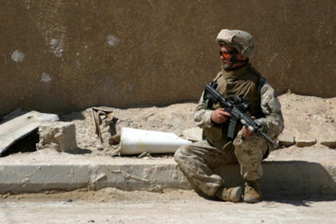 Sgt. Thomas Sellers, of the 6th Marine Regiment, 2nd Marine Division, remains alert during a quick break in conducting search operations in the city of Fallujah, Iraq, on June 1, 2005. Sellers and his fellow Marines of the 6th Marine Regiment, 2nd Marine Division, are working with the Multi-National Force-West in conducting counter-insurgency operations with Iraqi Security Forces. 