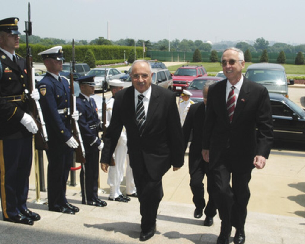 Turkey's Minister of National Defense Vecdi Gonul (left) is escorted through an honor cordon and into the Pentagon by Acting Deputy Secretary of Defense Gordon England (right). Gonul and England will meet to discuss defense issues of mutual interest. 