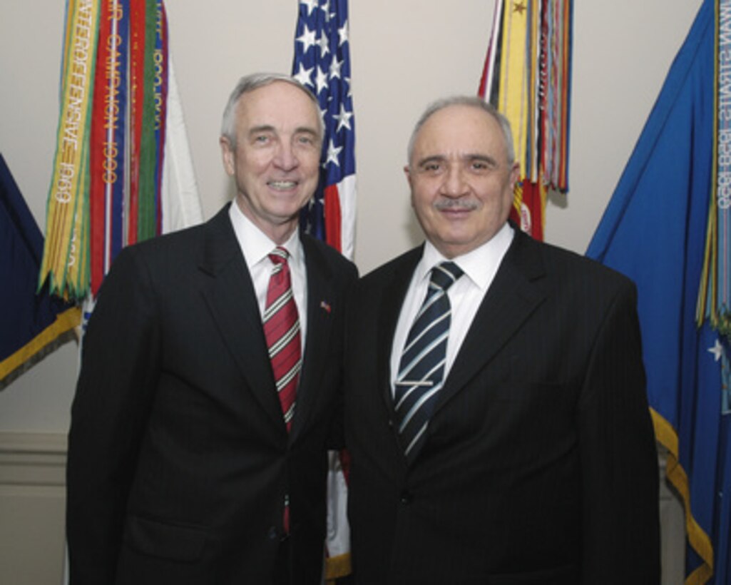 Acting Deputy Secretary of Defense Gordon England (left) poses for photographs with Turkey's Minister of National Defense Vecdi Gonul in the Pentagon on June 6, 2005. England and Gonul are meeting to discuss defense issues of mutual interest. 