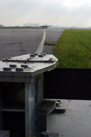 050607-M-4322H-001 MARINE CORPS AIR STATION FUTENMA, OKINAWA, Japan  - Marines from the aircraft recovery section, Headquarters and Headquarters Squadron, Marine Corps Air Station Futenma, honed their skills by arresting an F/A-18D Hornet, from MCAS Iwakuni here Jun. 6. Arresting, or trapping, is a process in which the aircraft's tail hook catches a stationary wire to stop the aircraft. Arrestment is much like the process used on aircraft carriers when tactical aircraft need to land on a limited or short runway. This is the first time many of the MCAS Futenma-based Marines have had an opportunity to take part in a hands-on training mission since February 2002. (Official U.S. Marine Corps photo by Lance Cpl. Martin R. Harris)(released)