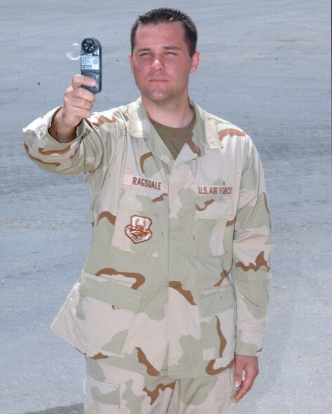 SOUTHWEST ASIA -- Senior Airman Michael Ragsdale demonstrates a portable backup method of obtaining weather readings.  Since weather is vital in flying operations, the weather observers let people know that it is more than just hot, humid and dusty.  Airman Ragsdale is a weather observer with the 380th Expeditionary Operations Support Squadron at a forward-deployed location and is from MacDill Air Force Base, Fla.  (U.S. Air Force photo by Senior Airman Elijah Roberts)