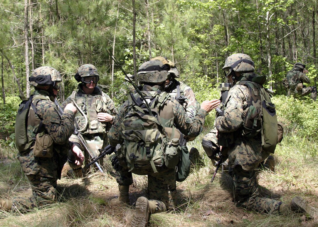 Members of the 22nd Marine Expeditionary Unit's (MEU) Maritime Special Purpose Force (MSPF) coordinate final preparations before assualting an objective during MSPF Interoperability Exercise June 8.  The course spanned June 6-17 and is one of many training evolutions conducted by the 22nd Marine Expeditionary Unit in preparation for it's deployment later this year.