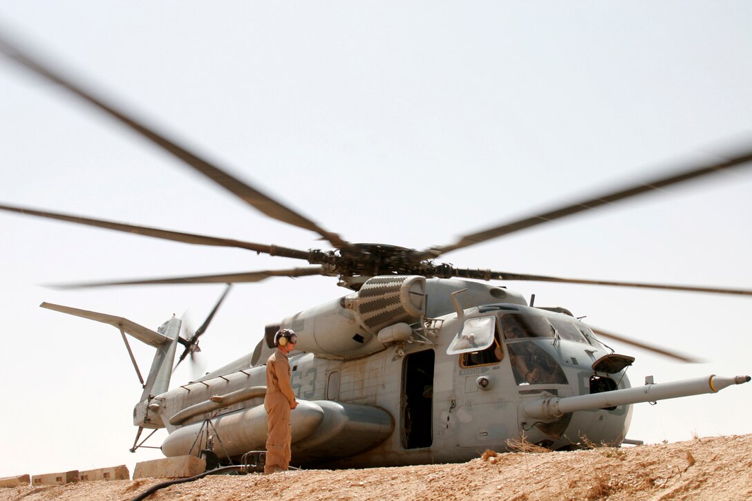 AL QAIM, Iraq ? Lance Cpl. Mark A. Moher, a bulk fuel specialist assigned to Marine Wing Support Squadron 271, Detachment Al Qaim waits for a signal to stop the flow of fuel during the refueling of a CH-53E Super Stallion from Marine Heavy Helicopter Squadron 465 on June 9.  Moher, a native of Naugatuck, Conn., is one of the seven Marines in the fuels section representing MWSS-271 here.