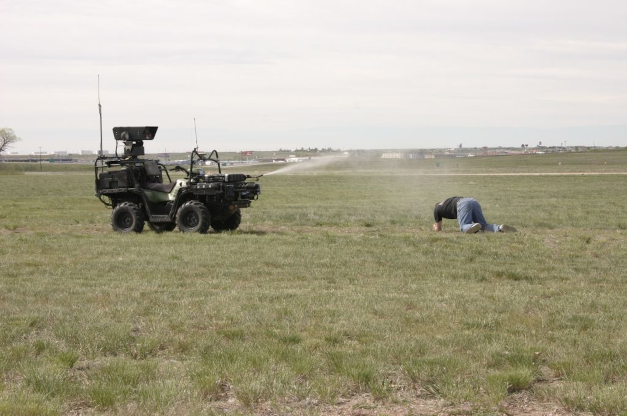 F.E. WARREN AFB, Wyo. - A robotic scout sprays simulated pepper spray at an aggressor demonstrating how remotely manned vehicles can conduct security forces missions here. The remote, detection, challenge and response system is an Air Force Research Laboratory initiative. (U.S. Air Force photo by 1st Lt. Darrick Lee) 