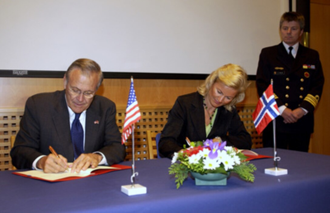 Secretary of Defense Donald H. Rumsfeld and Norwegian Minister of Defense Kristin Krohn Devold sign a Memorandum of Understanding for prepositioning U.S. Marine Corps equipment in Norway during a meeting at the Joint Warfare Center in Stavanger Sola Air Station, Norway, on June 8, 2005. 