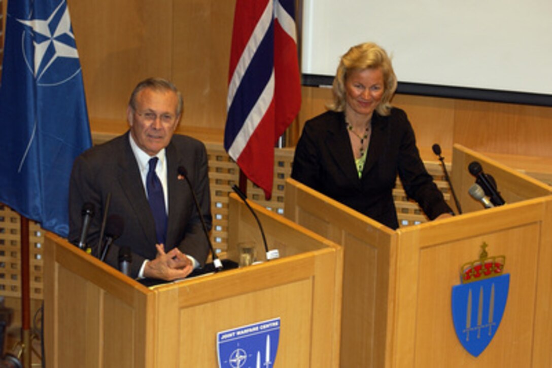 Secretary of Defense Donald H. Rumsfeld and Norwegian Minister of Defense Kristin Krohn Devold listen to a reporter's question during a press conference at the Joint Warfare Center in Stavanger Sola Air Station, Norway, on June 8, 2005. Rumsfeld and Devold signed a Memorandum of Understanding prior to the press conference that permits the U.S. to preposition U.S. Marine Corps equipment in Norway. 