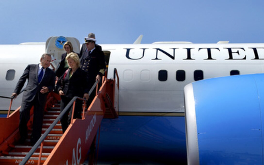 Secretary of Defense Donald H. Rumsfeld and Norwegian Minister of Defense Kristin Krohn Devold exit Rumsfeld's aircraft in Brussels, Belgium, on June 8, 2005. Rumsfeld and Devold flew from Norway to Belgium to attend a NATO conference with their counterparts. 