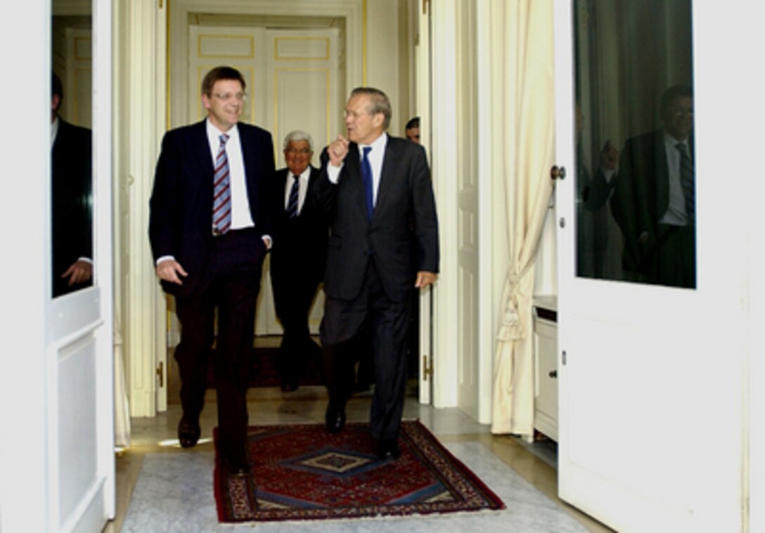 Belgian Prime Minister Guy Verhofstadt (left) and Secretary of Defense Donald H. Rumsfeld exit after a private meeting at his office in Brussels, Belgium, on June 8, 2005. Rumsfeld is in Belgium to meet with Verhofstadt and attend a NATO conference with his counterparts. 