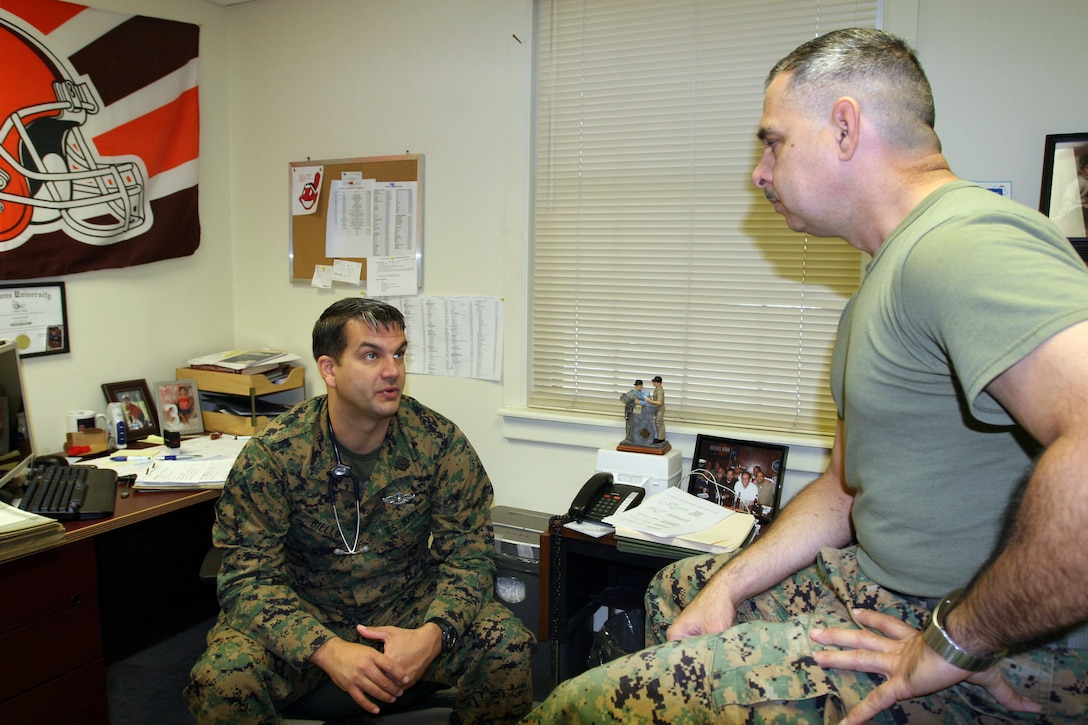 Petty Officer 1st Class Anthony Biello, independent duty corpsman, Group Aid Station, II Marine Expeditionary Force Headquarters Group, II MEF, counsels Master Sgt. William Rivera, field mess manager with MHG, on his ankle injury. Biello attended Independent Duty Corpsman School, which is 12 months long and goes beyond the basics of medicine into anatomy, physiology and how medicines affect the body.
