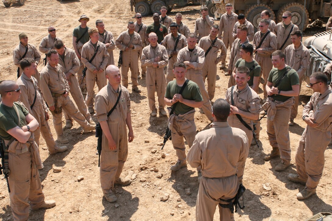Marines from Transportation Support Company listen to a briefing by 2nd Lt. Michael P. Lincoln, a convoy/platoon commander with the company at COP Timberwolf. The Marines arrived at the COP the day prior to deliver building materials and other supplies to assist in its construction.