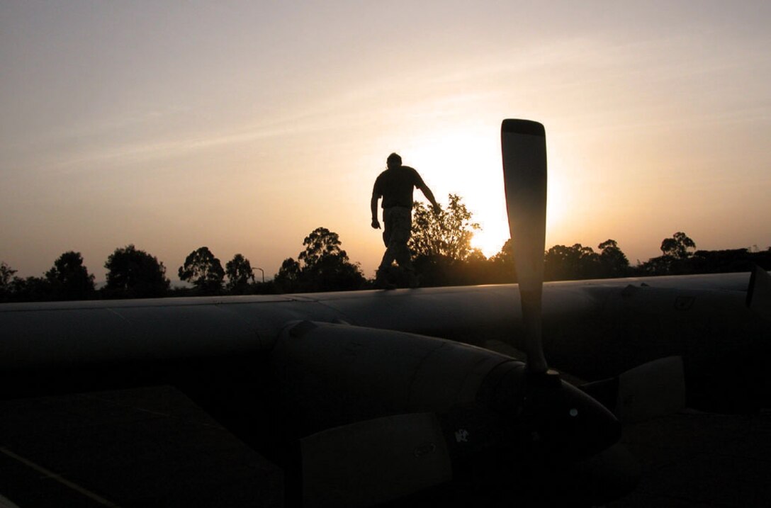 KENYA -- Master Sgt. Dan Schmitz (conducts) a final check of a C-130 Hercules before departure June 6.  More than 140 U.S. and Kenyan Army paratroopers left the Kenyan army base landing strip and made successful jumps during the three-day, 14-drop mission.  Sergeant Schmitz is a crew chief with the 746th Expeditionary Airlift Squadron at a forward-deployed location.  (U.S. Air Force photo by Tech. Sgt. Mark Munsey)