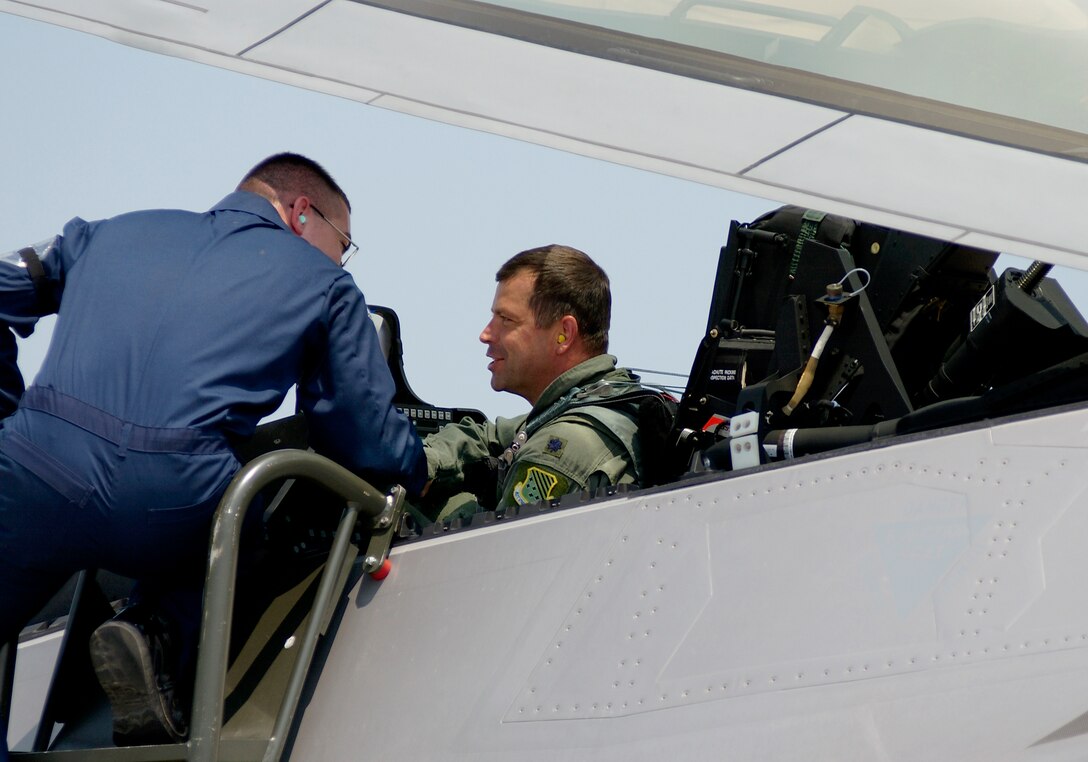 LANGLEY AIR FORCE BASE, Va. -- Airman 1st Class Richard Alexander greets Lt. Col. Wade Tolliver after he delivered the second permanent F/A-22 Raptor here June 8.  The third Raptor was also delivered June 8.  Colonel Tolliver is the 27th Fighter Squadron director of operations, and Airman Alexander is an F/A-22 assistant crew chief.  (U.S. Air Force photo by Tech. Sgt. Ben Bloker)