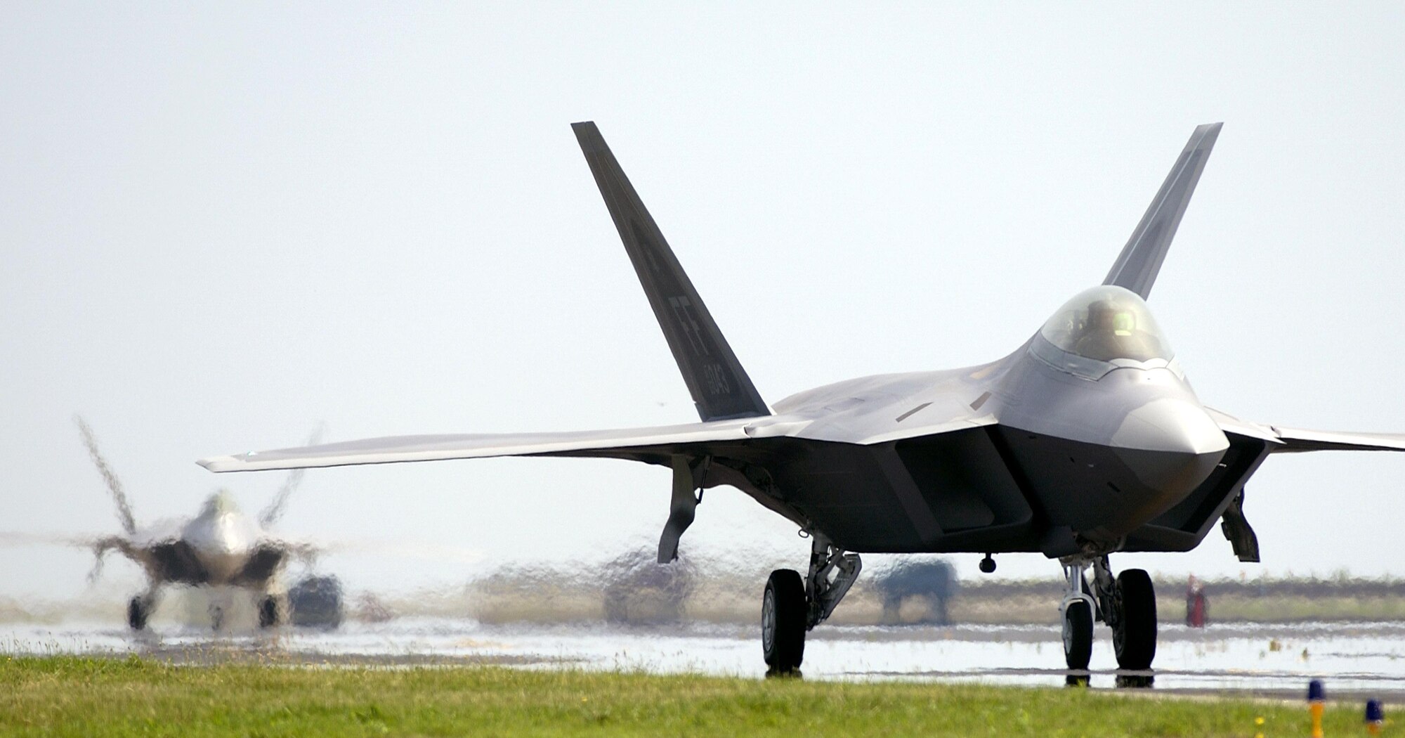 LANGLEY AIR FORCE BASE, Va. -- Lt. Col. Wade Tolliver delivers the second permanent F/A-22 Raptor here June 8.  Shortly after, Maj. Charles Corcoran delivered the base's third Raptor.  Colonel Tolliver is the 27th Fighter Squadron director of operations, and Major Corcoran is a pilot with the squadron.  (U.S. Air Force photo by Tech. Sgt. Ben Bloker)