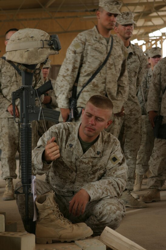 AL ASAD, Iraq (June 14, 2005) - Sergeant Merritt A. Dickenson, a Waynesboro, Pa., native, and military policeman, takes a final look at the identification tags hanging on the memorial of Lance Cpl. Marc L. Tucker.  Tucker, a Pontotoc, Miss., native, was attached to 4th Squad, MP Detachment, and deployed to Iraq to provide security for the explosive ordnance disposal team, recovery missions, engineer crater repair missions and convoys. Tucker lost his life while supporting Operation Iraqi Freedom 04-06. "He had the biggest heart in the Marine Corps," said Dickenson. "He was always there when you needed him. He never quit."