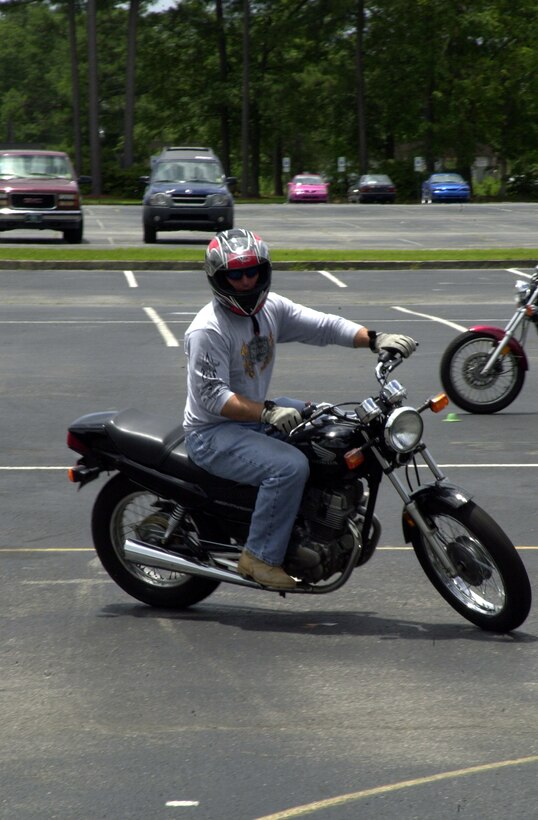 JACKSONVILLE, N.C. -- Corporal David Shirley, a heavy-machine gunner with Weapons Company, 1st Battalion, 2d Marines, rides through a circuit course June 11 at Coastal Carolina Community College. Shirley, who survived a motorcycle crash a year ago, took the course to improve his abilities and learn the proper way to ride a motorcycle. "I guess if there is one thing I can share with everyone, it's to make sure to your wearing all your riding gear," he said. "Never drink and drive. I was lucky. My accident could have been a lot worse." (Official Marine Corps photo by Lance Cpl. Shane Suzuki)