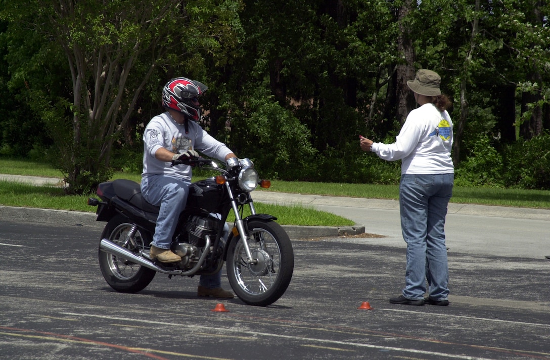 JACKSONVILLE, N.C. -- Corporal David Shirley, a heavy-machine gunner with Weapons Company, 1st Battalion, 2d Marines, takes instruction from motorcycle safety instructor Debbie Hangsleben June 11 at Coastal Carolina Community College. Shirley, who survived a motorcycle crash a year ago, took the course to improve his abilities and learn the proper way to ride a motorcycle. "I guess if there is one thing I can share with everyone, it's to make sure to your wearing all your riding gear," he said. "Never drink and drive. I was lucky. My accident could have been a lot worse." (Official Marine Corps photo by Lance Cpl. Shane Suzuki)