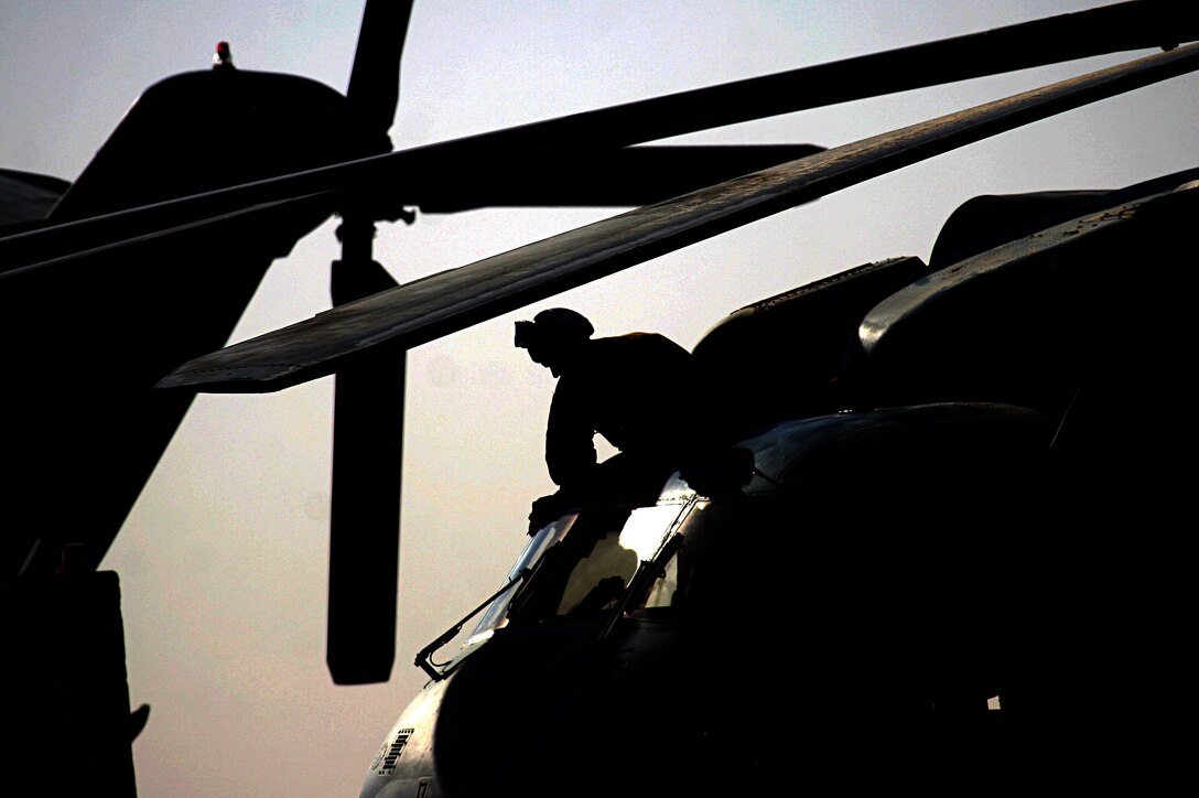 AL ASAD, Iraq (June 14, 20005) - Sgt. Evan A. Lavounty, airframes mechanic and native of Davis, Calif., wipes down the windows on a CH-53 Super Stallion during preflight checks.