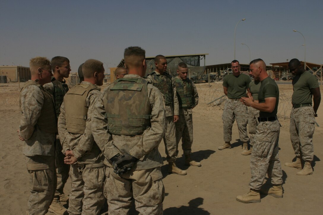 AL ASAD, Iraq (June 23, 2005) - Staff Sgt. Paul Denning, company gunnery sergeant for Transportation Support Company, Combat Logistics Battalion 2, 2d Force Service Support Group (Forward) - otherwise known as "Team Carnivore"- explains the grey belt techniques to the Marines in his martial arts course before demonstrating them.  Denning, a Whitehouse Station, N.J., native, is a black belt instructor in the Marine Corps Martial Arts Program, and wants to train as many of the more than 200 Marines in his company up at least one martial arts belt higher than they are now.