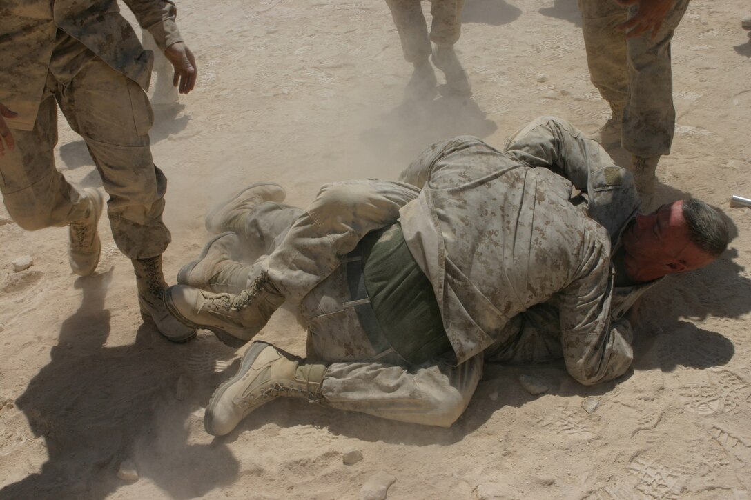 AL ASAD, Iraq (June 23, 2005) - One of the Marines decides to test out his grey belt skills on his instructor Staff Sgt. Paul Denning, a black belt instructor in the Marine Corps Martial Arts Program, after graduating the martial arts course. Denning, a Whitehouse Station, N.J., native and company gunnery sergeant for Transportation Support Company, Combat Logistics Battalion 2, 2d Force Service Support Group (Forward) - otherwise known as "Team Carnivore"- wants to train as many of the more than 200 Marines in his company up at least one martial arts belt higher than they are now.