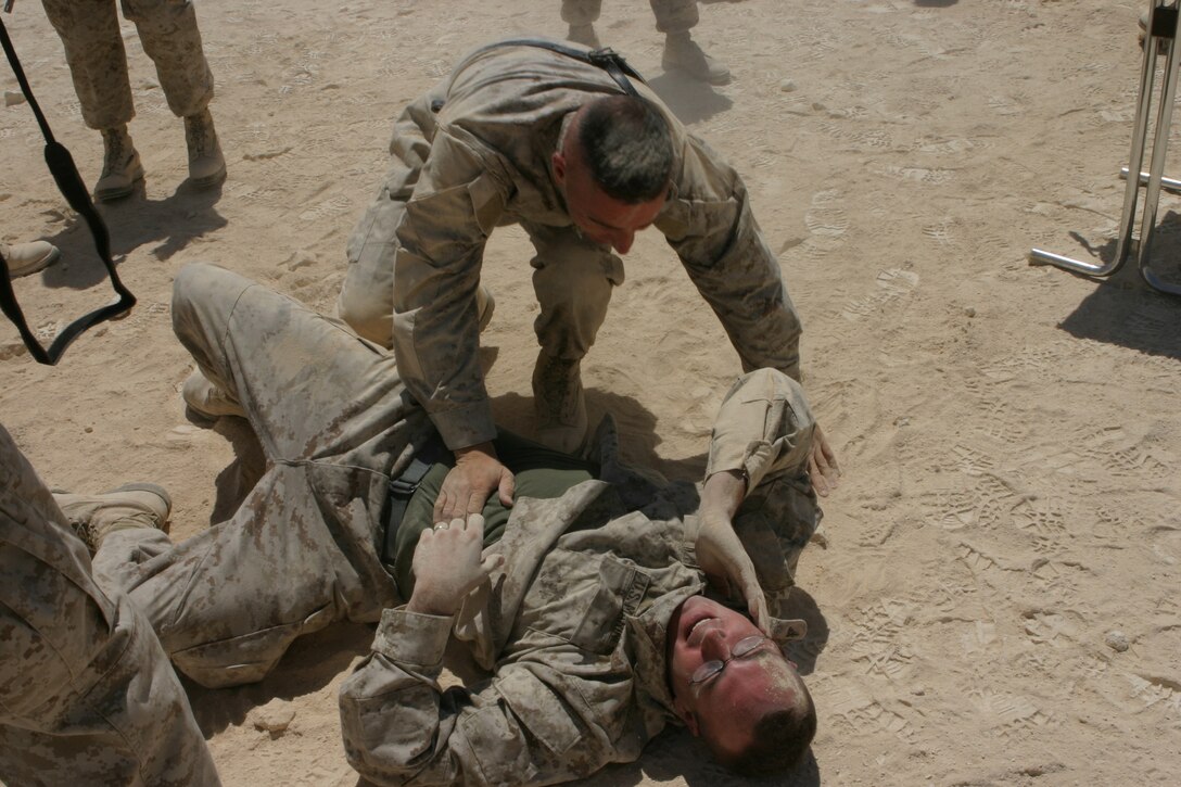 AL ASAD, Iraq (June 23, 2005) - One of the Marines decides to test out his grey belt skills on his instructor Staff Sgt. Paul Denning, a black belt instructor in the Marine Corps Martial Arts Program, after graduating the martial arts course. Denning, a Whitehouse Station, N.J., native and company gunnery sergeant for Transportation Support Company, Combat Logistics Battalion 2, 2d Force Service Support Group (Forward) - otherwise known as "Team Carnivore"- wants to train as many of the more than 200 Marines in his company up at least one martial arts belt higher than they are now.