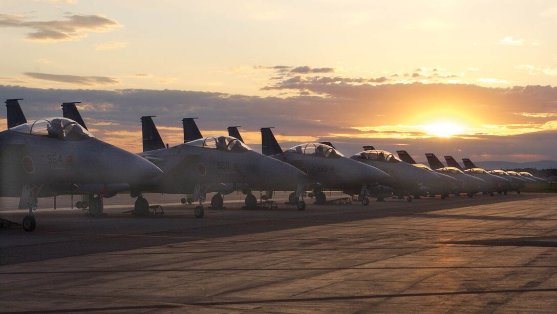 EIELSON AIR FORCE BASE, Alaska -- The sun sets June 8 behind Japanese F-15s and F-16 Fighting Falcons from the Texas Air National Guard's 149th Fighter Wing.  (U.S. Air Force photo by Airman 1st Class Justin Weaver)