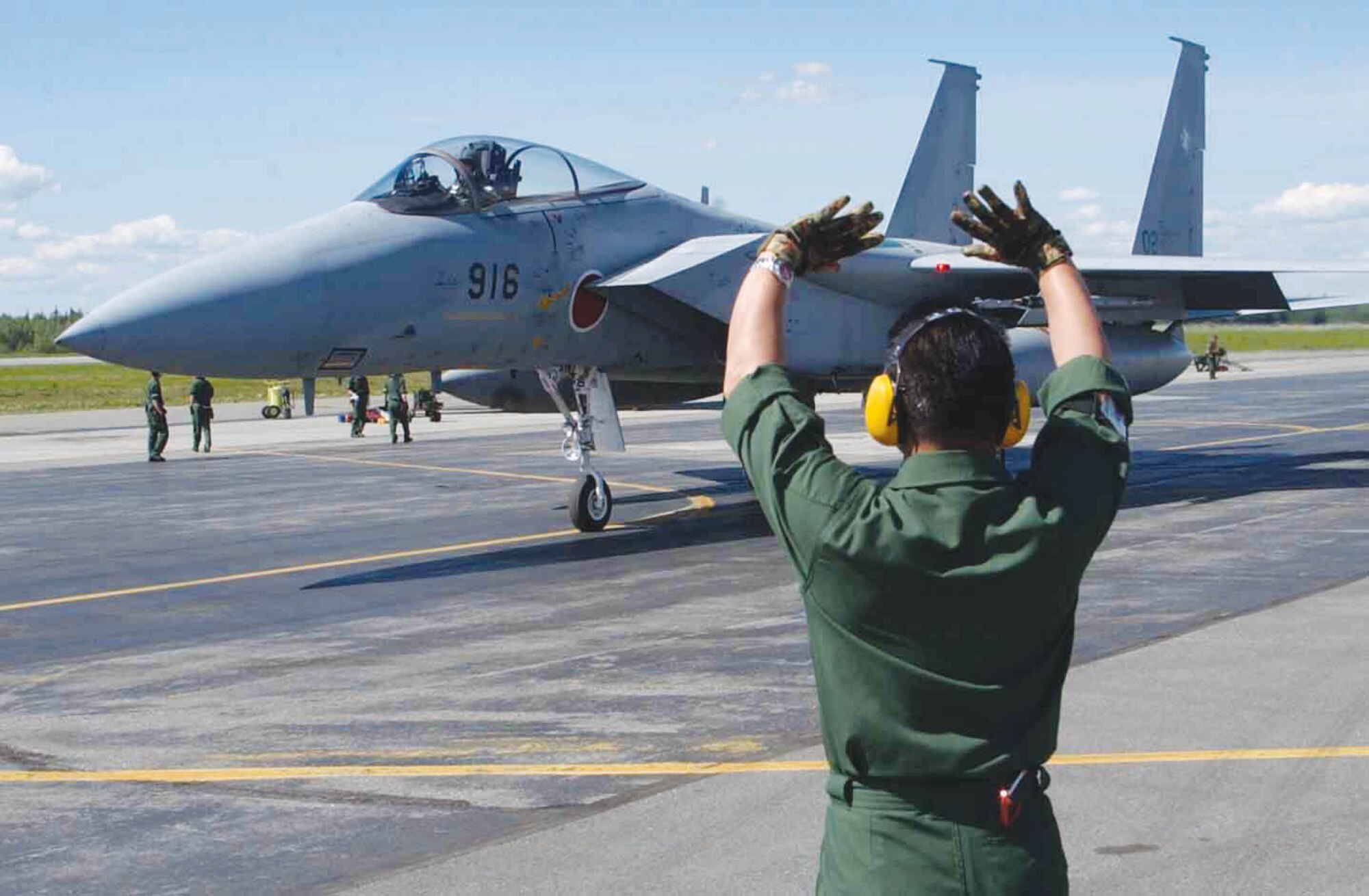 EIELSON AIR FORCE BASE, Alaska -- A Japanese crew chief marshals an F-15 on the flightline June 7.  This is the third consecutive year Japanese F-15s have participated in Cooperative Cope Thunder.  (U.S. Air Force photo by Airman 1st Class Justin Weaver) 