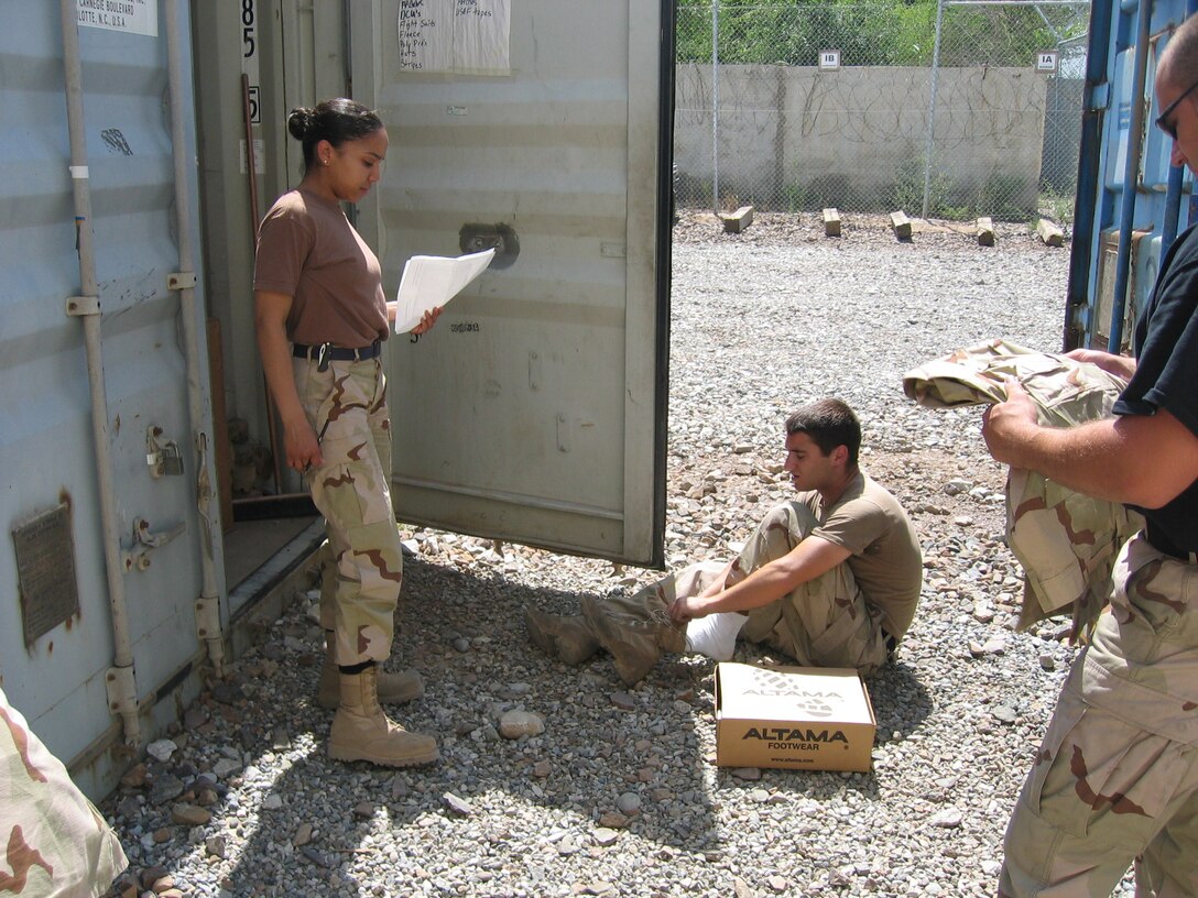 KARSHI-KHANABAD AIR BASE, Uzbekistan -- Airman 1st Class Diana Ortiz issues new boots to an Airman here.  She is a supply management apprentice with the 416th Expeditionary Mission Support Squadron's supply section and is deployed from Royal Air Force Mildenhall, England.  (U.S. Air Force photo by Staff Sgt. Shad Eidson)