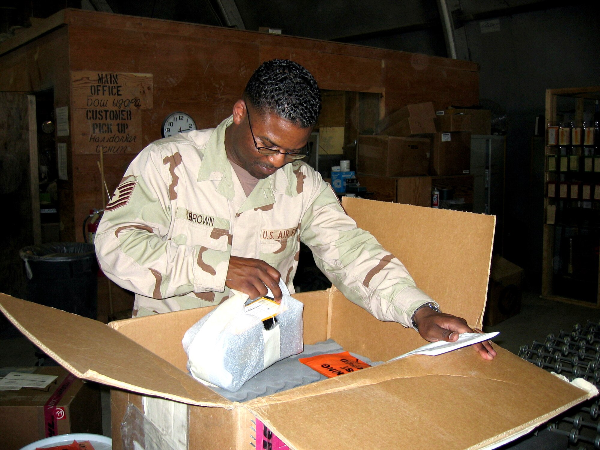 KARSHI-KHANABAD AIR BASE, Uzbekistan -- Tech. Sgt. Johnny Brown inspects a shipment for accuracy and contraband.  He is the 416th Expeditionary Mission Support Squadron's supply section superintendent and is deployed from Royal Air Force Mildenhall, England.  (U.S. Air Force photo by Staff Sgt. Shad Eidson)