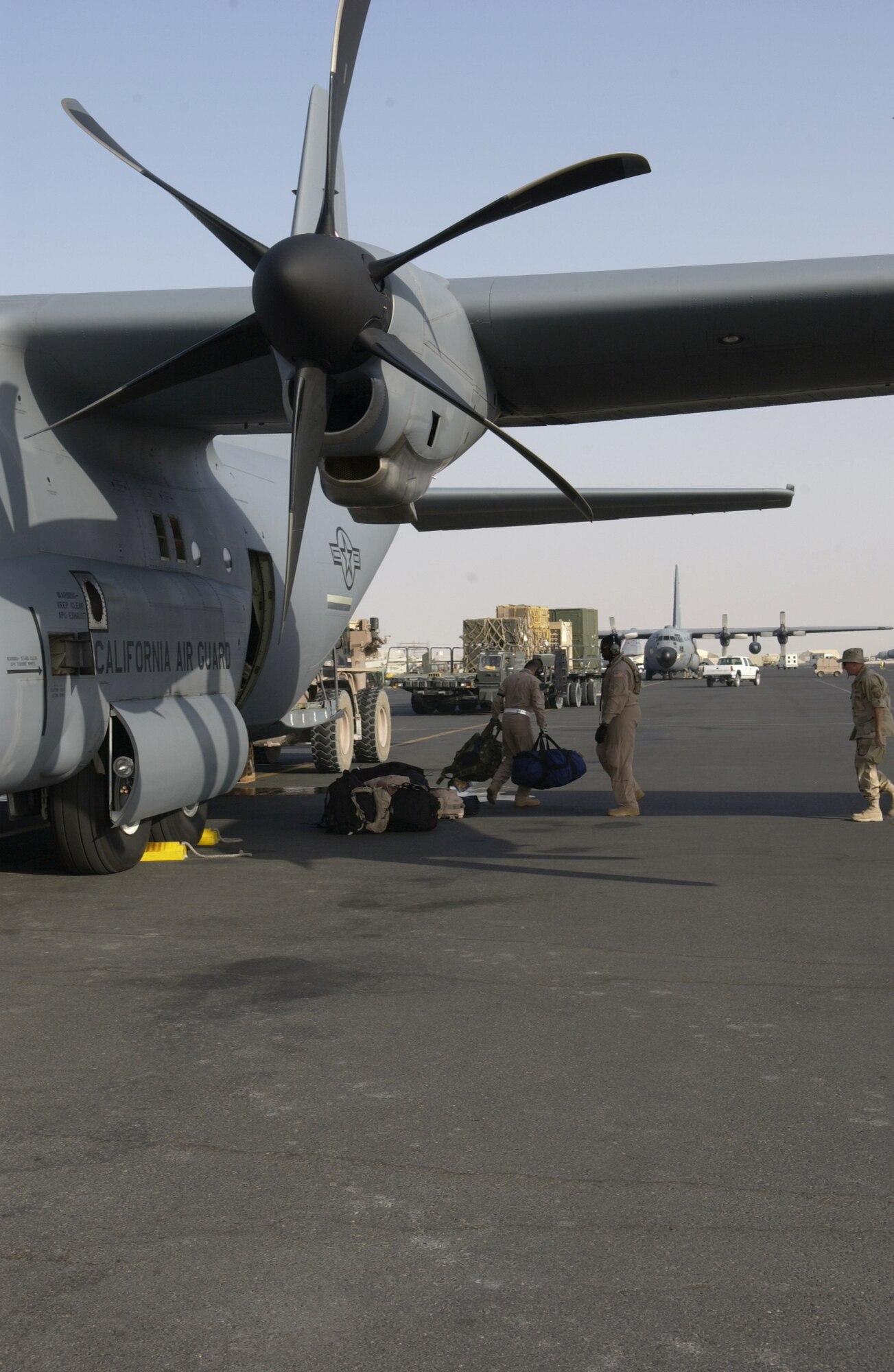 SOUTHWEST ASIA -- Airmen unload a C-130J Hercules after its arrival at a forward-deployed location here June 7 supporting operations in Iraq, Afghanistan and the Horn of Africa.  The aircraft is from the California Air National Guard's 146th Airlift Squadron.  (U.S. Air Force photo by Tech. Sgt. Randy Mallard)