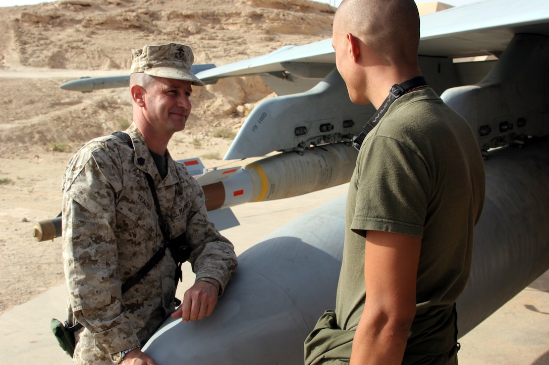 AL ASAD, Iraq - Gunnery Sgt. Steven Teague, the administration chief with Marine Fighter Attack Squadron 142 talks with a Marine on the flightline. Seeing Teague on the flightline is a normal sight for the Gators. He reaches out to his Marines that have administrative issues by leaving his office and visiting them on the flightline. He calls it his personal touch method of administrating.