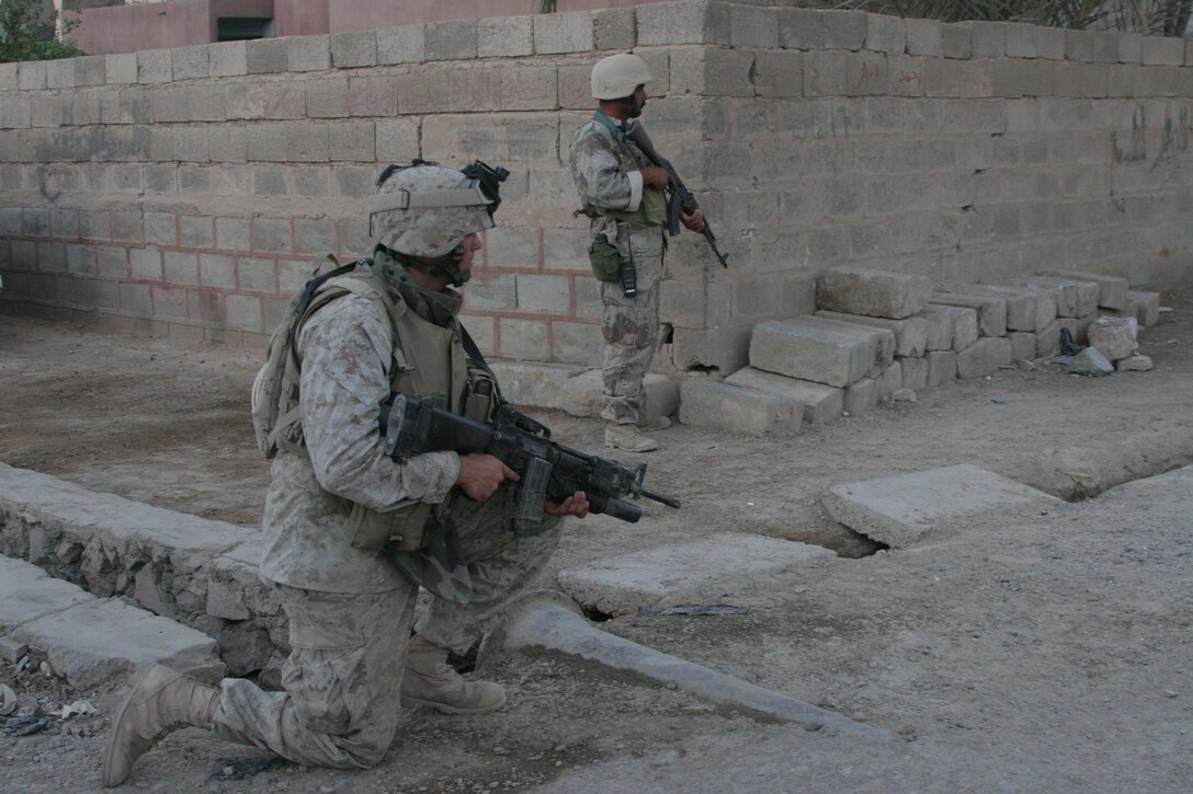 HIT, Iraq (June 29, 2005)- Iraqi soldiers and Marines with 3rd Battalion, 25th Marine Regiment, Regimental Combat Team-2 conduct a patrol and cordon and knock in the city during Operation Guardian Sword conducted to clear the city and set-up Iraqi Security Forces firm bases through out the city. The Marines of 2d Marine Division conduct counter-insurgency operations with Iraqi Security Forces to isolate and neutralize anti-Iraqi forces, to support the continued development of Iraqi Security Forces, and to support Iraqi reconstruction and democratic elections in order to create a secure environment that enables Iraqi self-reliance and self-governance. (Official USMC photo by Lance Cpl. Lucian Friel )(RELEASED)