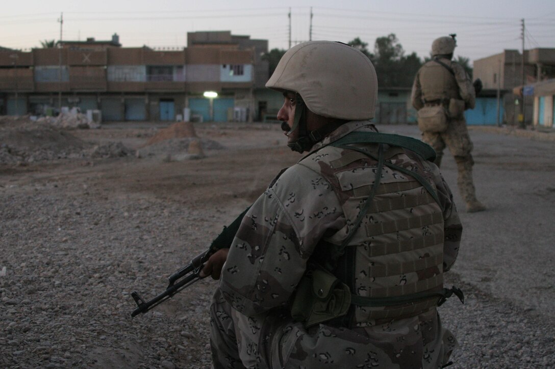HIT, Iraq (June 29, 2005)- Iraqi soldiers and Marines with 3rd Battalion, 25th Marine Regiment, Regimental Combat Team-2 conduct a patrol and cordon and knock in the city during Operation Guardian Sword conducted to clear the city and set-up Iraqi Security Forces firm bases through out the city. The Marines of 2d Marine Division conduct counter-insurgency operations with Iraqi Security Forces to isolate and neutralize anti-Iraqi forces, to support the continued development of Iraqi Security Forces, and to support Iraqi reconstruction and democratic elections in order to create a secure environment that enables Iraqi self-reliance and self-governance. (Official USMC photo by Lance Cpl. Lucian Friel )(NOT RELEASED)