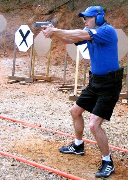 ATLANTA -- Maj. Roger Sherman lines up his shot during a practical shooting competition here.  Practical shooting measures a person's ability to shoot rapidly and accurately with a full power handgun, rifle or shotgun.  Major Sherman is one of four people on the U.S. National Production Team who will be competing at the International Practical Shooters Confederation World Shoot XIV in August.  (Courtesy photo)