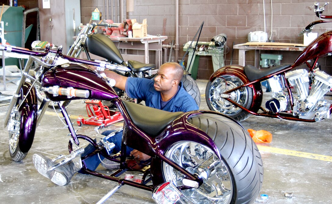 HICKAM AIR FORCE BASE, Hawaii -- Tech. Sgt. Greg Price runs a brake line on a pro street chopper he is building to show in the 3rd Annual Choppers-Only Show in Honolulu.  This is the 14th bike he has built in the past four years.  He is a C-40B aircraft crew chief with the 15th Airlift Maintenance Squadron here.  (U.S. Air Force photo by Tech. Sgt. Martin Jackson)