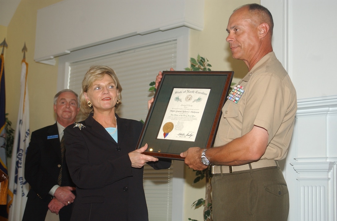 MARINE CORPS BASE CAMP LEJEUNE, N.C. - Lieutenant Gov. Beverly Purdue presents Maj. Gen. Robert C. Dickerson, commanding general, Marine Corps Base, with the Long Leaf Pine award for his history of service to the community at the Paradise Point Officer's Club June 13.   The Long Leaf Pine award is presented to an individual for dedication and extended length to an organization as the State of North Carolina's highest honor. Purdue presented the award on behalf of North Carolina Gov. Mike Easley.   Past recipients of the award include Charles Kuralt, Maya Angelou and Reverend Billy Graham. (Official Marine Corps photo by Pfc. Drew Barker)