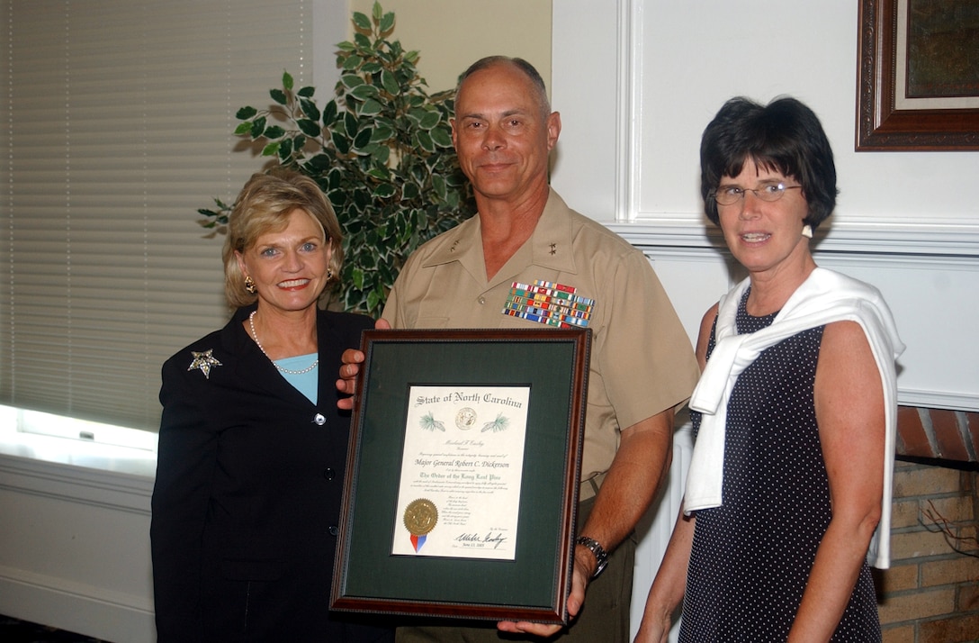 MARINE CORPS BASE CAMP LEJEUNE, N.C. - Major Gen. Robert C. Dickerson, commanding general, Marine Corps Base, stands with Lt. Gov. Beverly Purdue (left), and his wife, Karen, after receiving the Long Leaf Pine award for his history of service to the community at the Paradise Point Officer's Club June 13.   The Long Leaf Pine award is presented to an individual for dedication and extended length to an organization as the State of North Carolina's highest honor. Purdue presented the award on behalf of North Carolina Gov. Mike Easley. (Official Marine Corps photo by Pfc. Drew Barker)