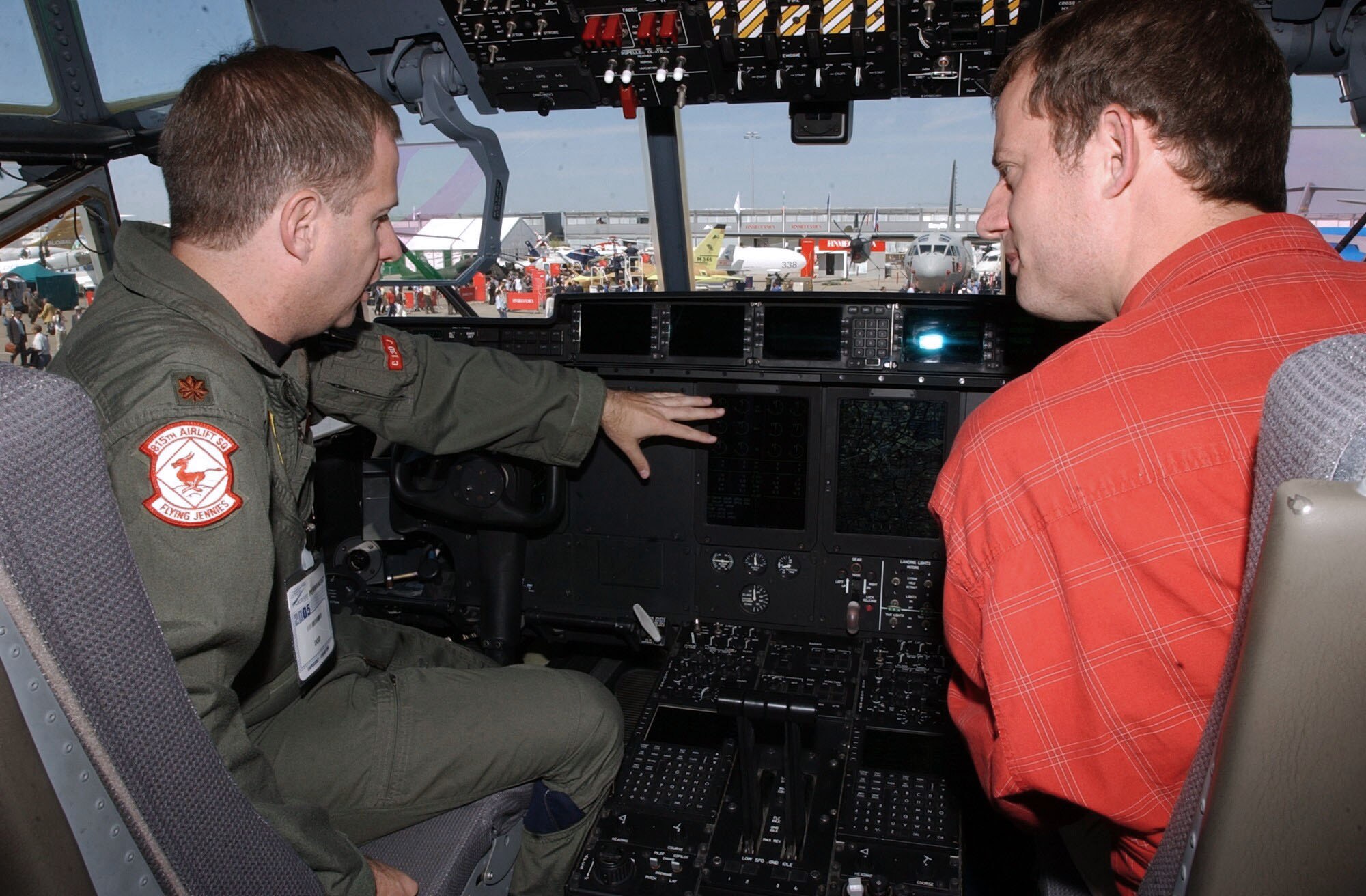 PARIS -- Maj. Brian Freeman explains the devices of a J-model C-130 Hercules cockpit to a French aeronautical journalist June 14 at the Paris Air Show.  He is a reservist with the 815th Airlift Squadron at Keesler Air Force Base, Miss.  (U.S. Air Force photo by Senior Airman Amaani Lyle)