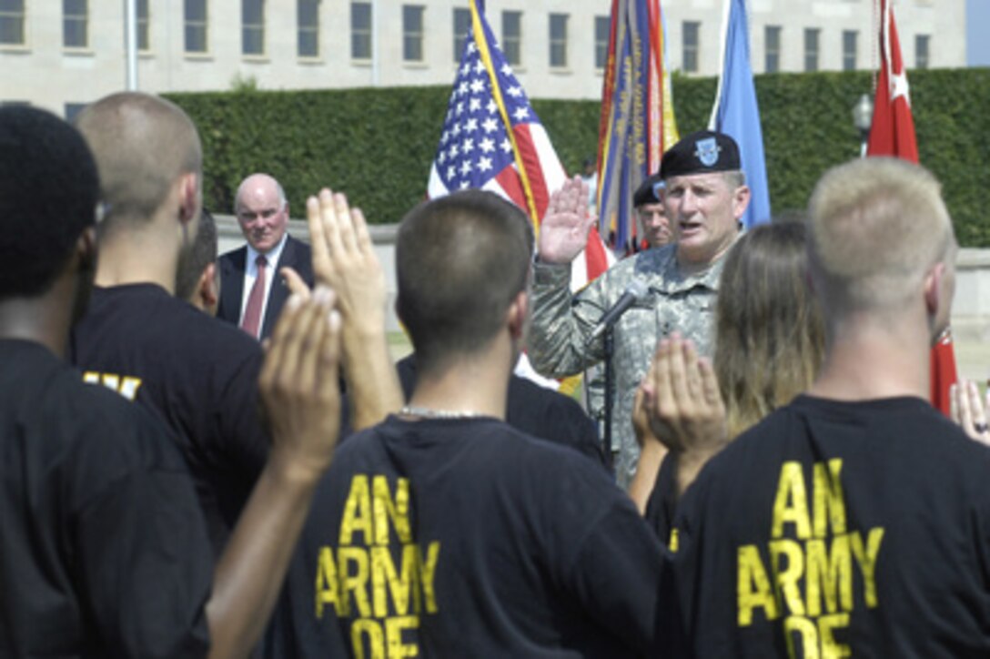 Army Chief of Staff Gen. Peter Schoomaker administers the oath of office to a group of about 30 new Army volunteers from the recruiting district of Baltimore, Md., during Pentagon ceremonies marking the 230th anniversary of the Army's founding on June 14, 2005. Secretary of the Army Francis J. Harvey (left) looks on. Each new volunteer was dressed in a black t-shirt with the Army slogan "An Army of One." 