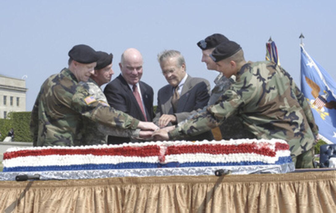 Secretary of Defense Donald H. Rumsfeld (right center) joins Secretary of Army Francis J. Harvey (left center) and U.S. Army soldiers including Chief of Staff Gen. Peter Schoomaker (2nd from right) and Sergeant Major of the Army Kenneth O. Preston (2nd from left) in cutting the Army's birthday cake on June 14, 2005. The birthday celebration was held on the Pentagon parade field marking the 230th anniversary of the founding of the senior military service. 