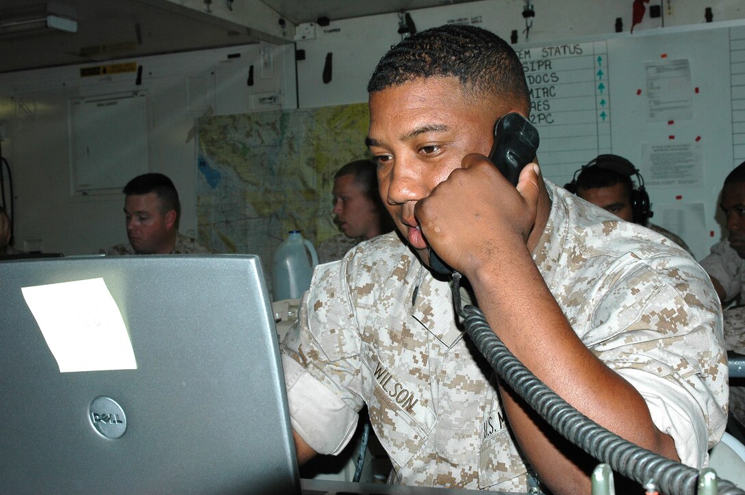 Staff Sgt. Columbus Wilson, the crew chief at Marine Air Command Group-28, coordinates information with a Marine on the flight line at Exercise Desert Talon.