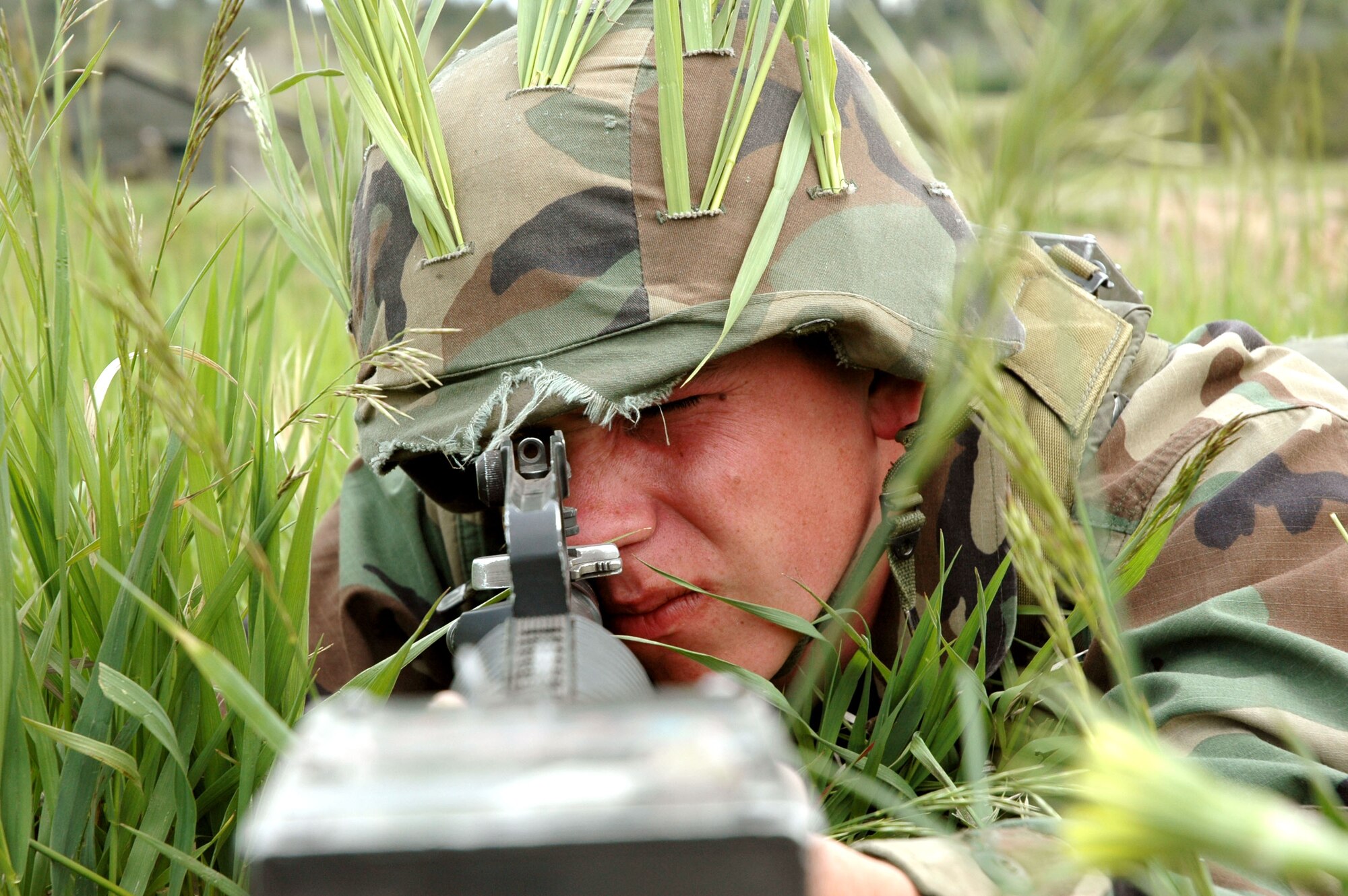 U.S. AIR FORCE ACADEMY, Colo. -- Cadet 3rd Class Nathan Haney looks for movement in the surrounding area to ensure camp security June 10 during Global Engagement 2005.  Defensive fighting positions were manned to combat against cadre when they tested the cadets training, trying to infiltrate the camp and take over during war day.  This was the first of six groups of cadets to go through the training throughout the summer.  (U.S. Air Force photo by Tech. Sgt. Matt Gilreath)
