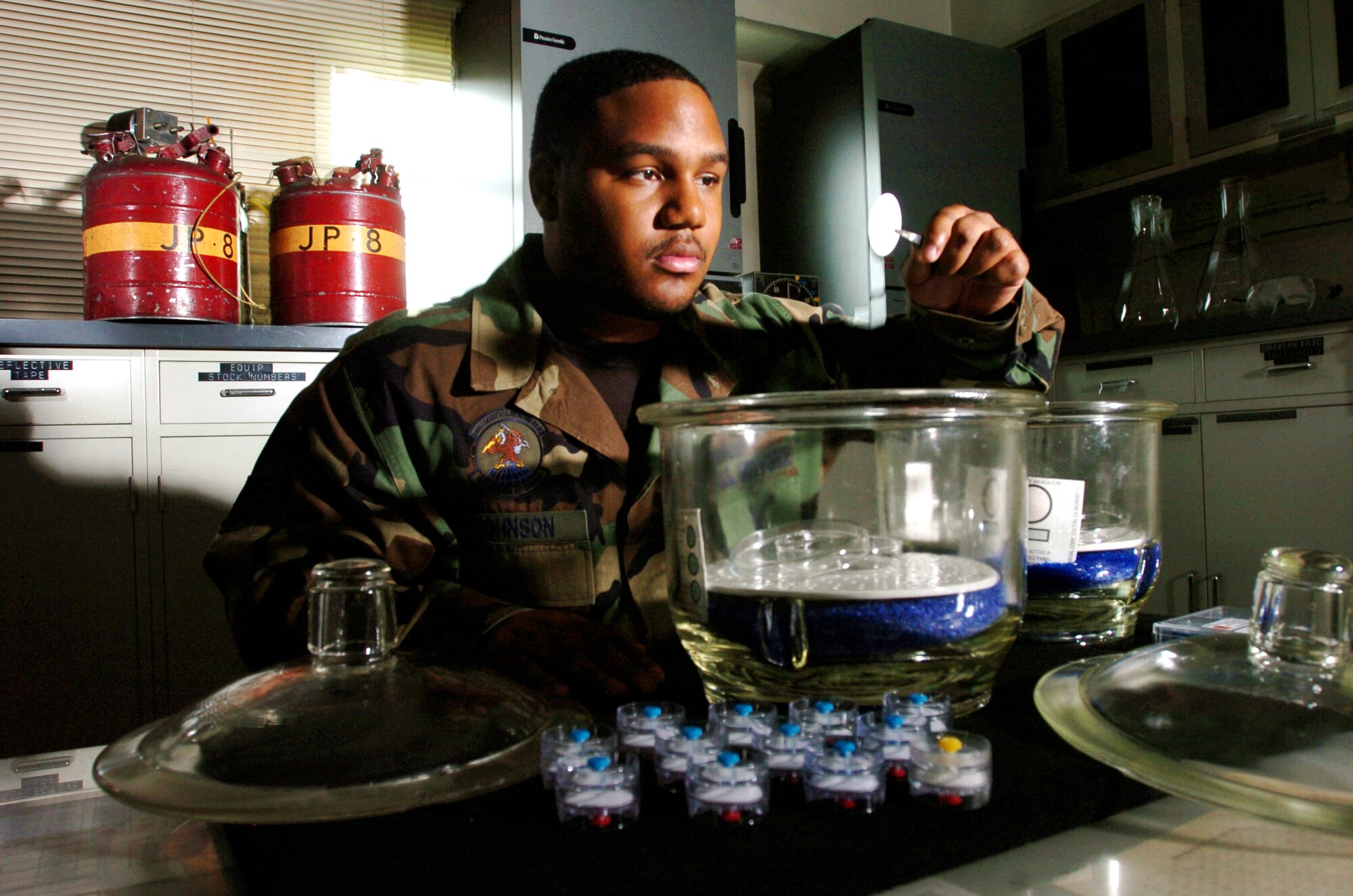 YOKOTA AIR BASE, Japan -- Staff Sgt. Carmarius Johnson dries residual fuel from a filter.  He is inspecting the filters to ensure they are free of contaminants.  He is a fuels laboratory technician with the 374th Logistics Readiness Squadron here.  (U.S. Air Force photo by Master Sgt. Val Gempis)