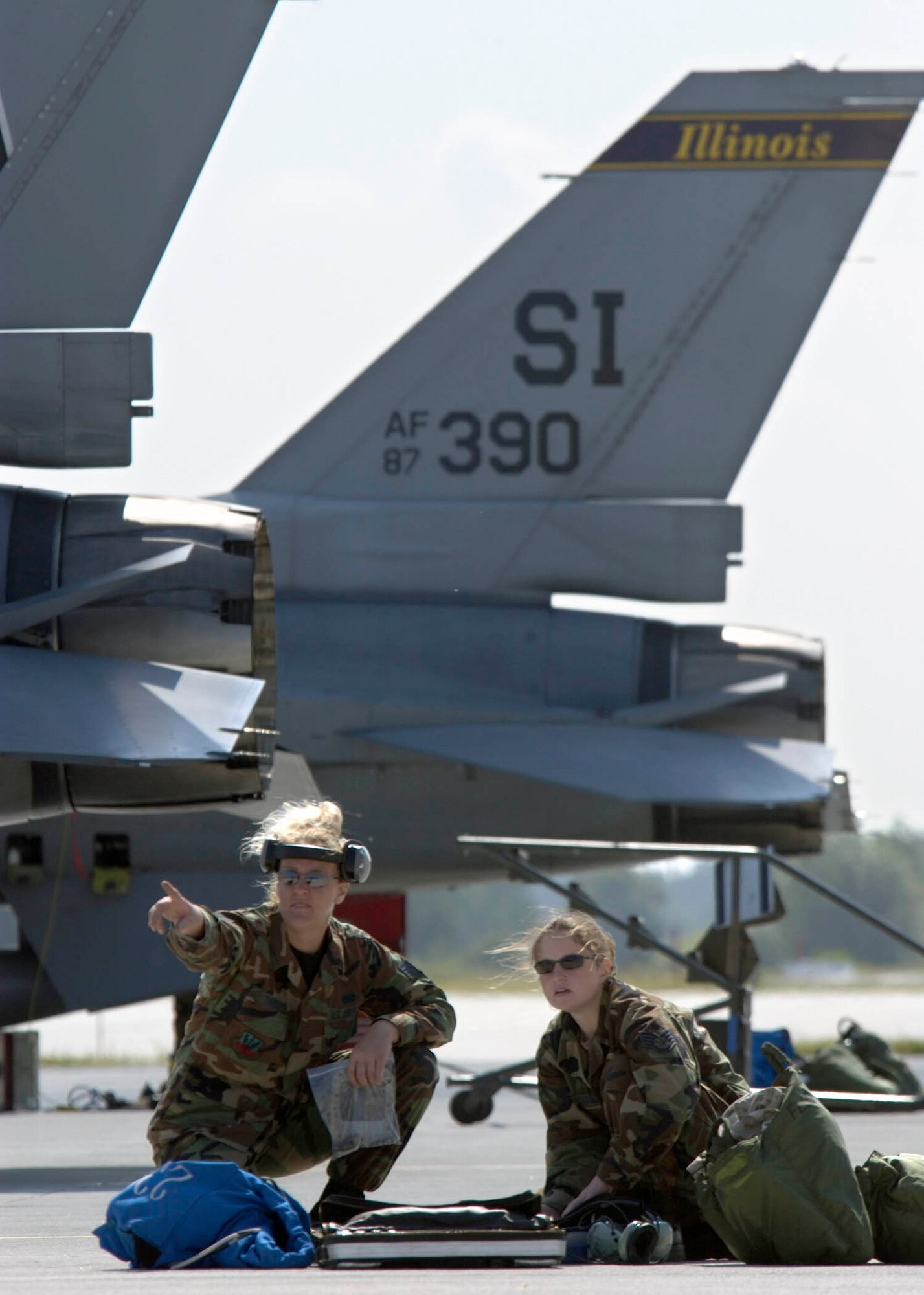 POZNAN, Poland -- Staff Sgt. Valentina Thoele (left) discusses F-16 Fighting Falcon operations with Staff Sgt. Loni Gotschall here.  The Airmen are from the Illinois Air National Guard's 183rd Fighter Wing, and they are familiarizing Polish airmen with the F-16 during the U.S. European Command exercise Sentry White Falcon 2005 through June 17.  In 2006, the Polish air force will start receiving their own F-16s that will begin replacing their Soviet-made MiG fighters as the country modernizes its military to NATO standards.  (U.S. Air Force photo by Master Sgt. John E. Lasky)