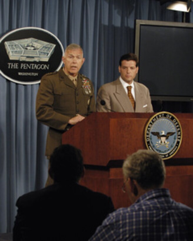 Joint Staff Director for Operations Lt. Gen. James T. Conway, U.S. Marine Corps, (left) responds to a reporter's question during a Pentagon press briefing on June 16, 2005. Conway and Principal Deputy Assistant Secretary of Defense for Public Affairs Lawrence Di Rita (right) conducted the briefing. 